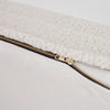 Close-up of a white dog bed with a visible zipper detail