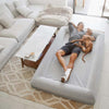 Man relaxing with a dog on an XXL grey dog bed