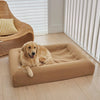 Golden Retriever relaxing on a chai-coloured dog bed