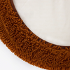 Fur seal slip cover for a Barneycles Curl dog bed featuring a textured brown edge
