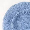 Powder blue dog bed with a textured surface designed for comfort and style