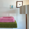 Pink and green dog bedding stacked neatly, suitable for Australian made dog beds.