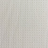 Close-up texture of a white non slip dog bed fabric with small raised dots