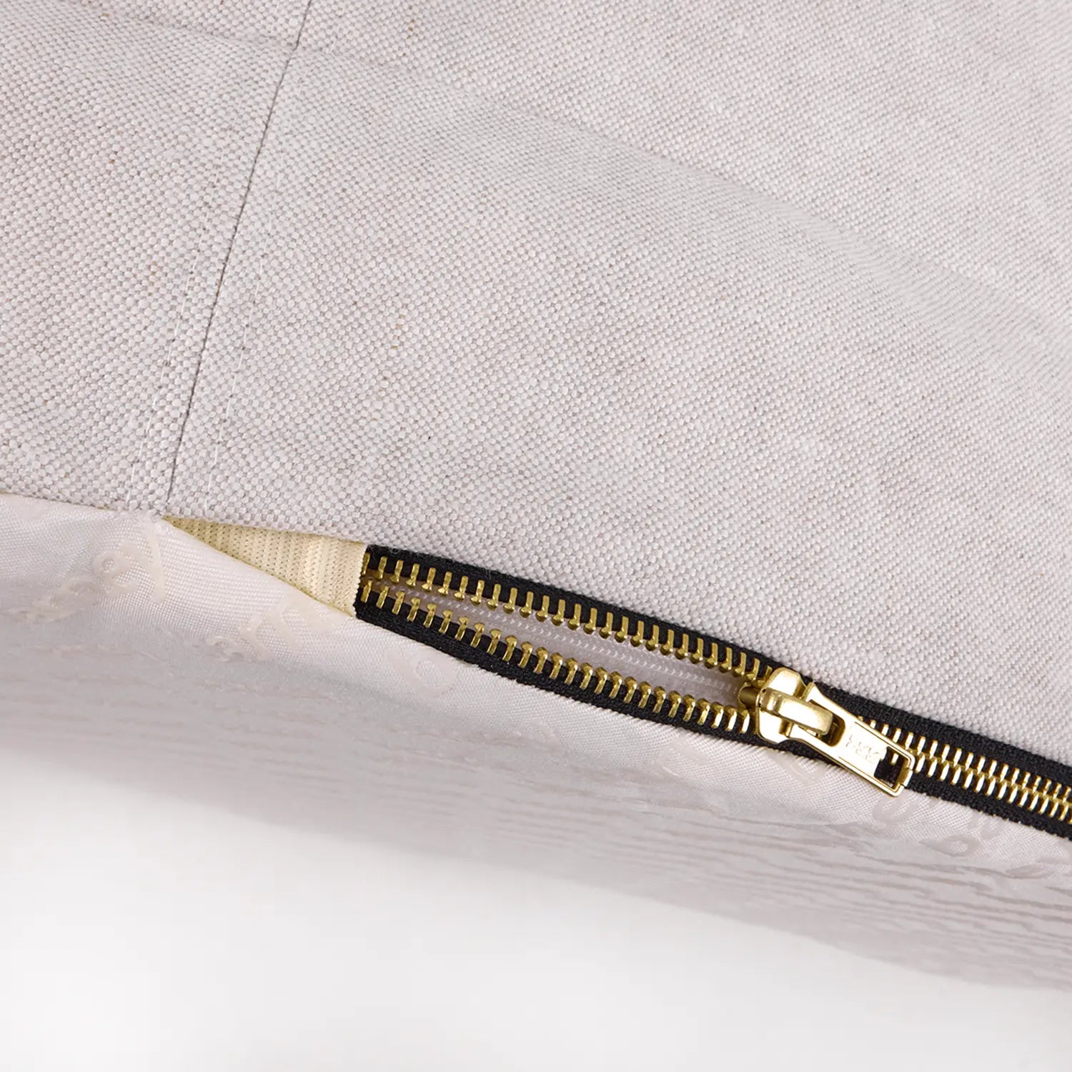 Close-up of an oat linen dog bed zipper showing the quality and detail of the fabric and stitching
