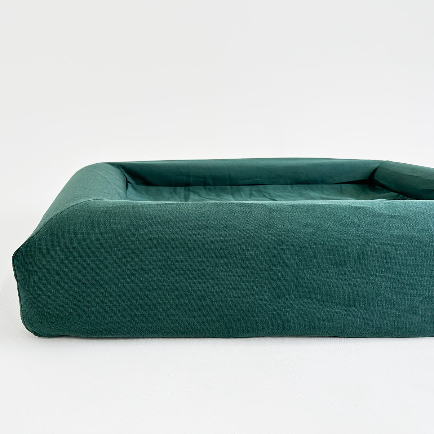 Green XL dog bed with raised edges for comfort and support