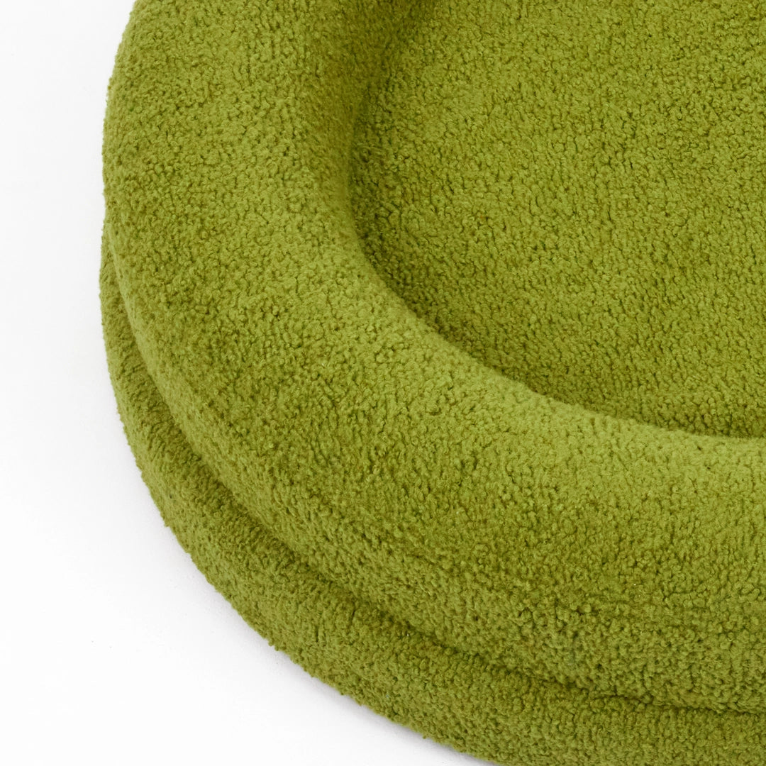 Green luxury dog bed with soft, textured fabric designed for comfort and style