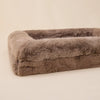 Large luxury dog bed with soft, plush fabric in a neutral tone