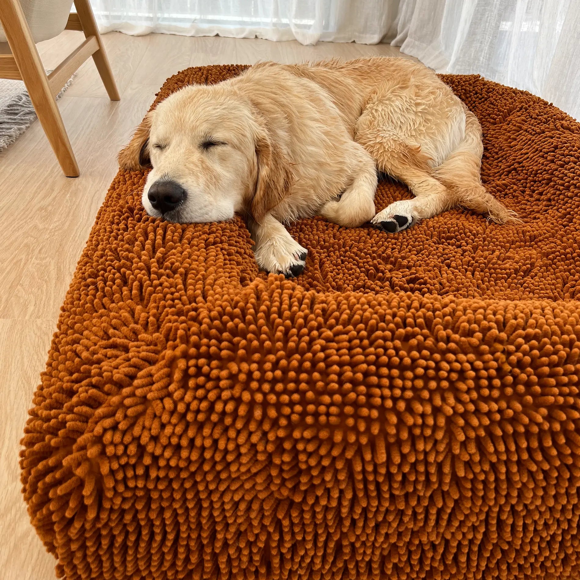 Golden Retriever resting on a fur seal coloured dog bed