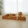 Golden Retrievers relaxing on a large golden dog mattress