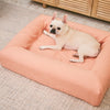 French Bulldog relaxing on a linen pink dog bed